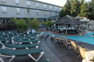 A shot of the Commodore Resort and MIST Pool Bar, during calm hours.